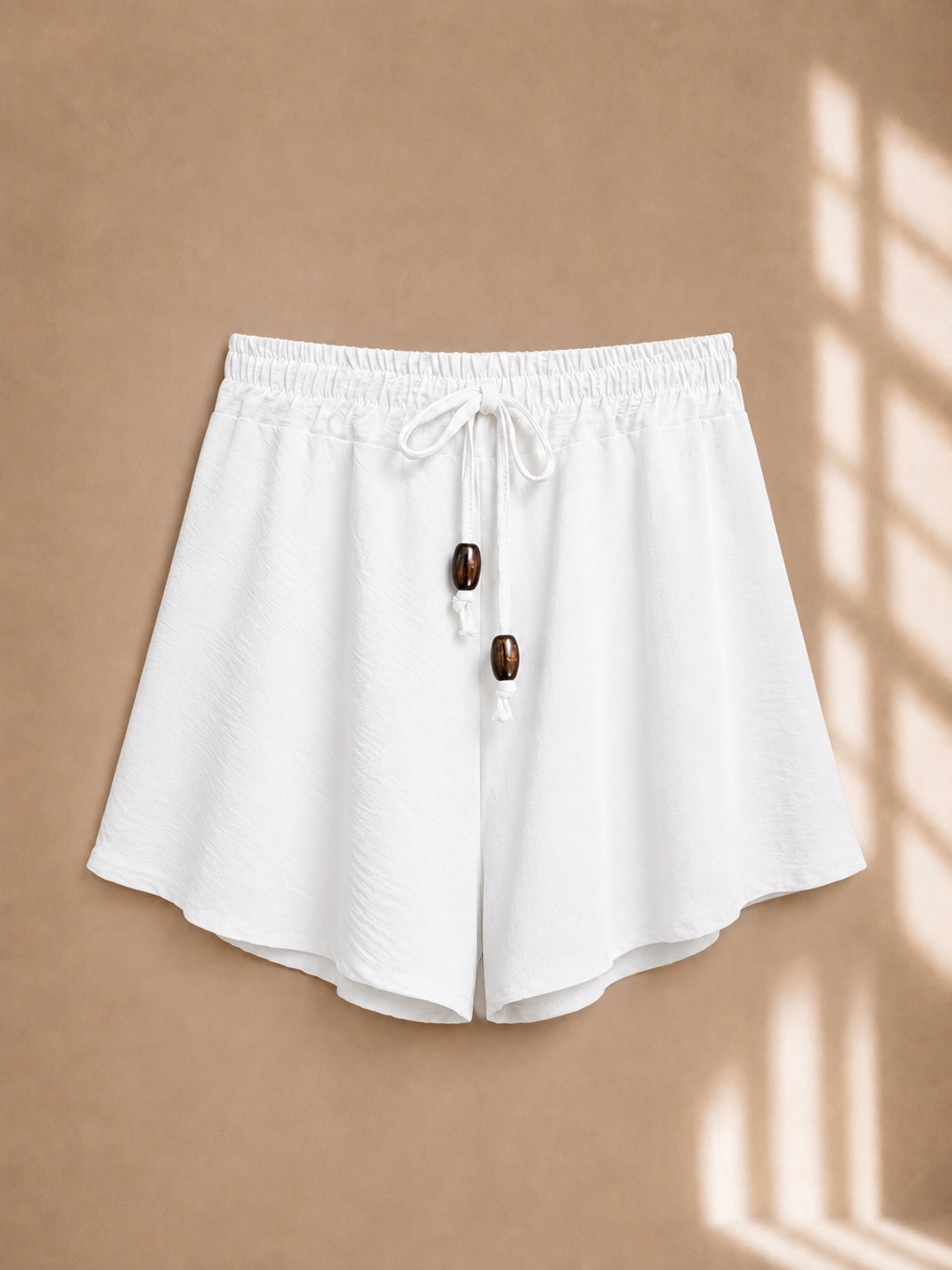 Shorts con coulisse e perline